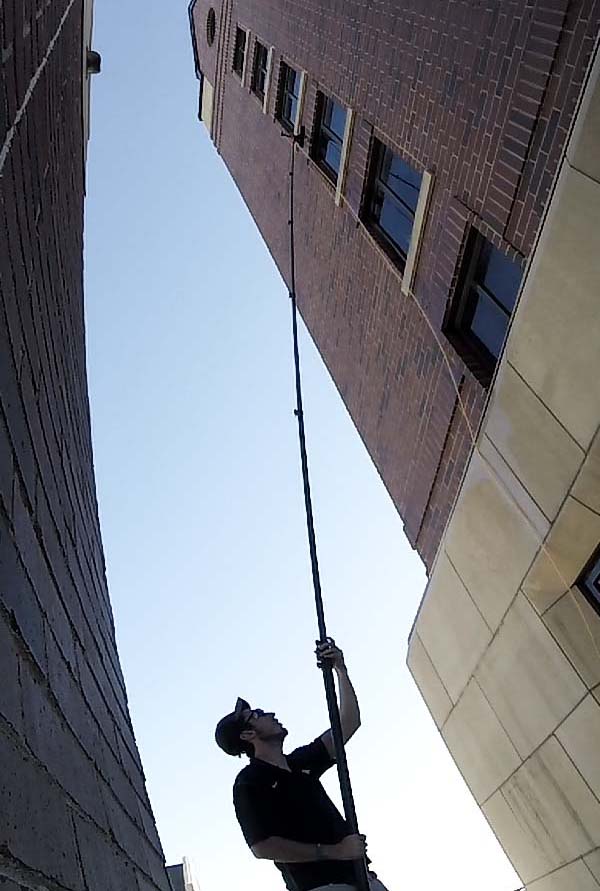 Cleaning a tall building with a Water-Fed System